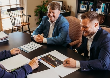Mark Myers and Brayden Stringer speaking with client